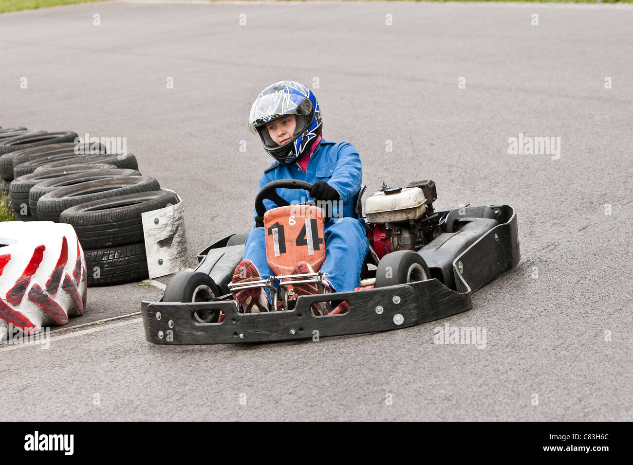 children racing go-carts on track Stock Photo