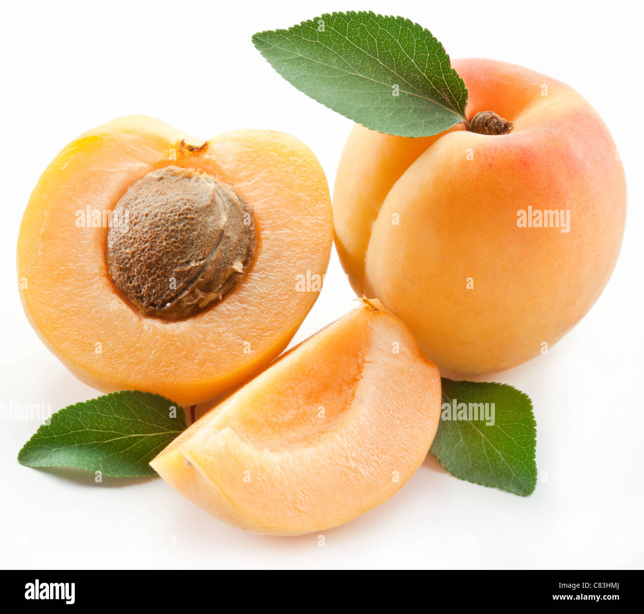 Apricots with leaves on a white background Stock Photo - Alamy