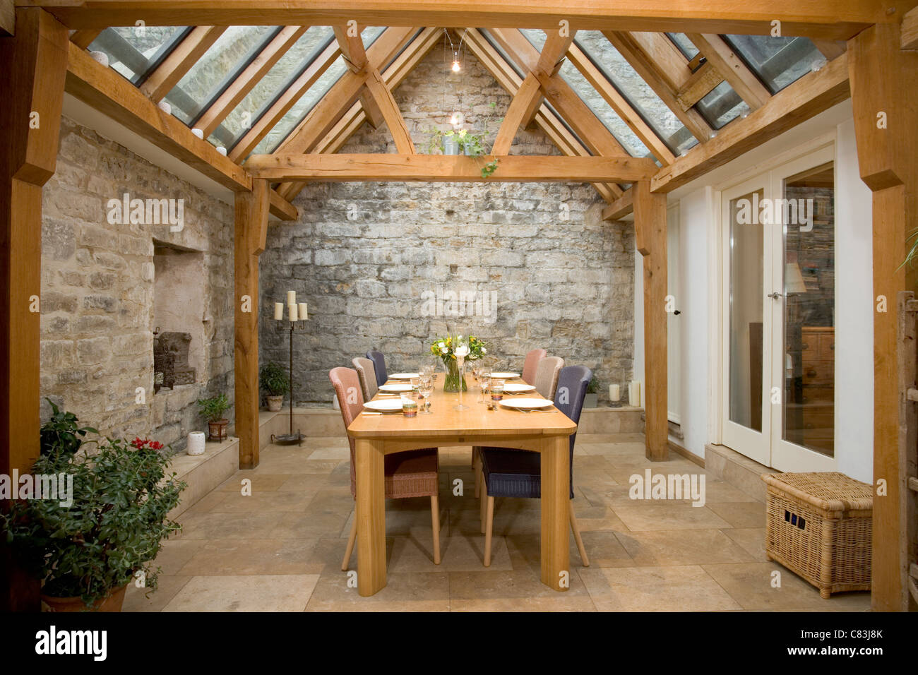 Contemporary oak framed glass roofed dining room. Stock Photo