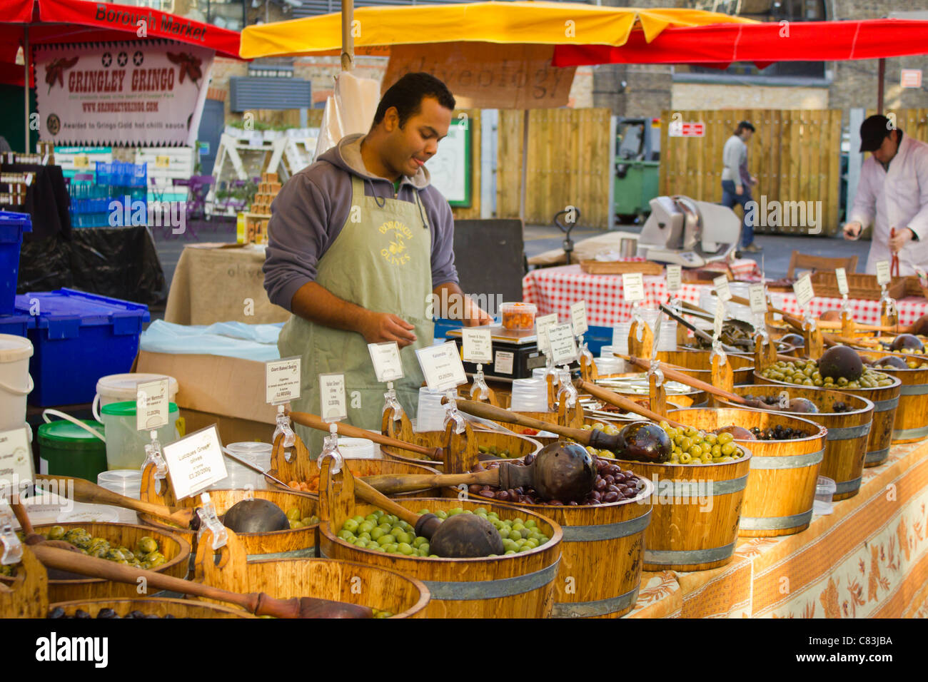 Market trader at a olive stall at Borough Market. Stock Photo