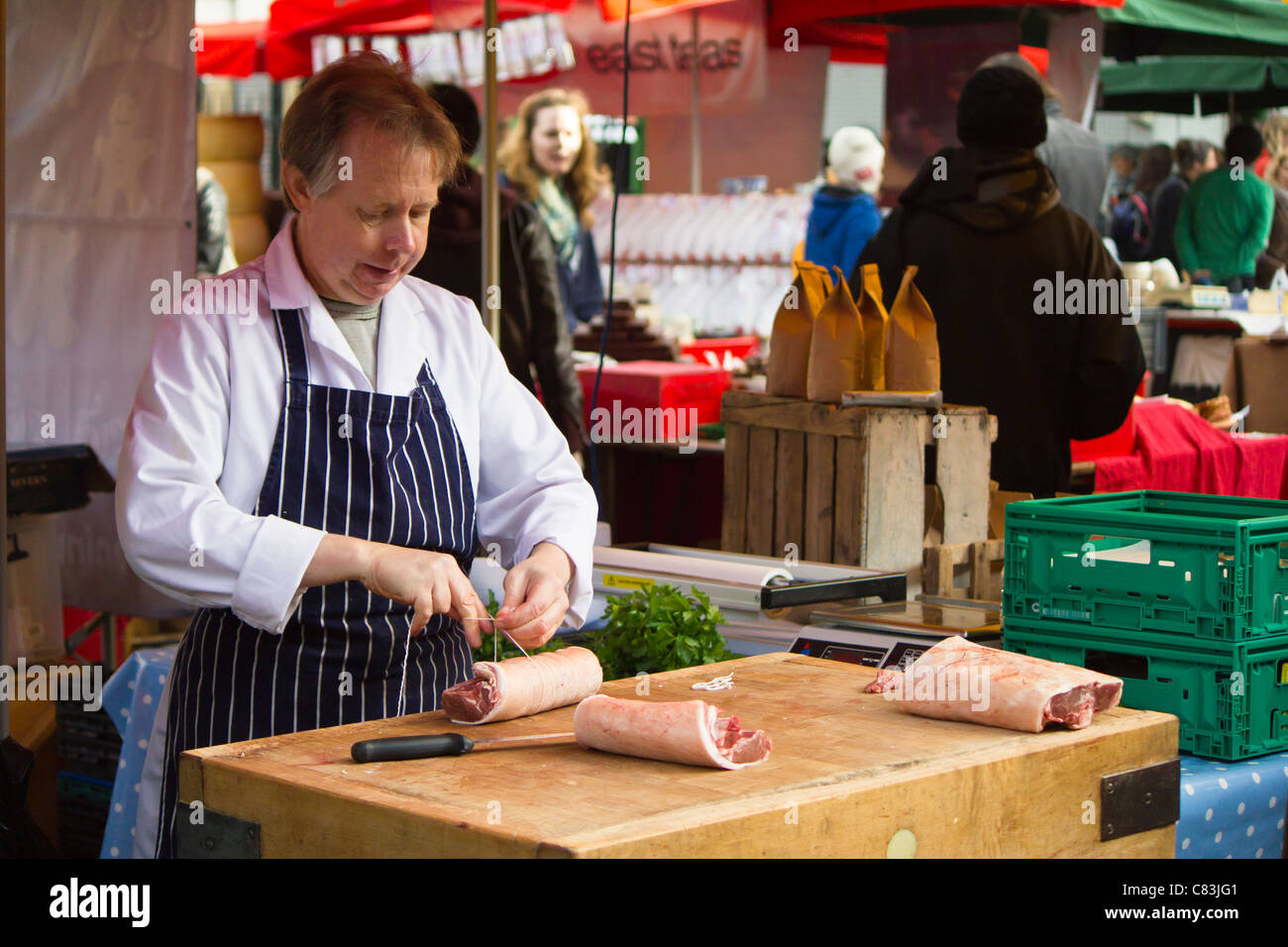Butcher at a market stall in Borough Market Stock Photo Alamy