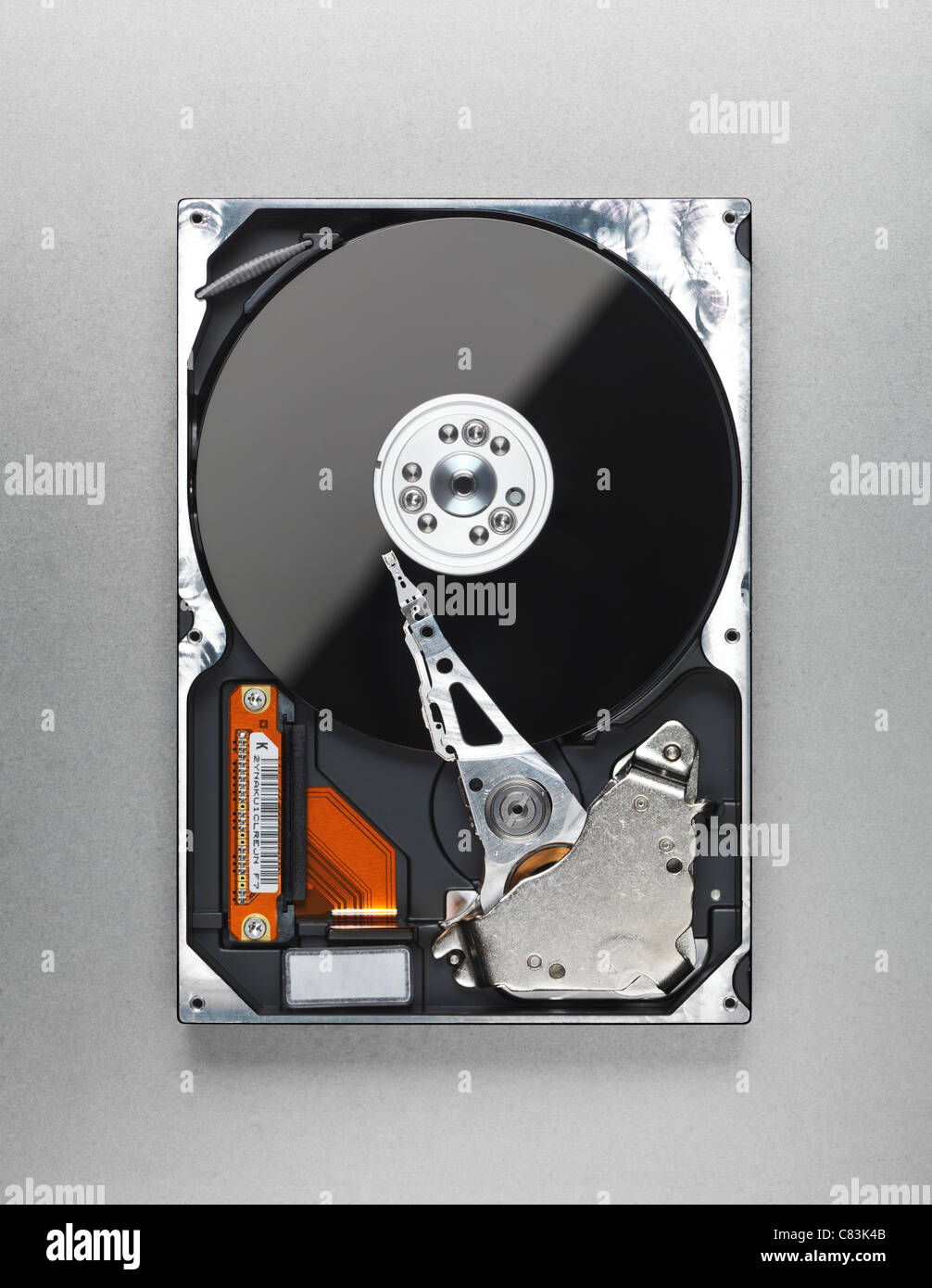 Open computer hard disk drive HDD isolated on metallic background Stock Photo