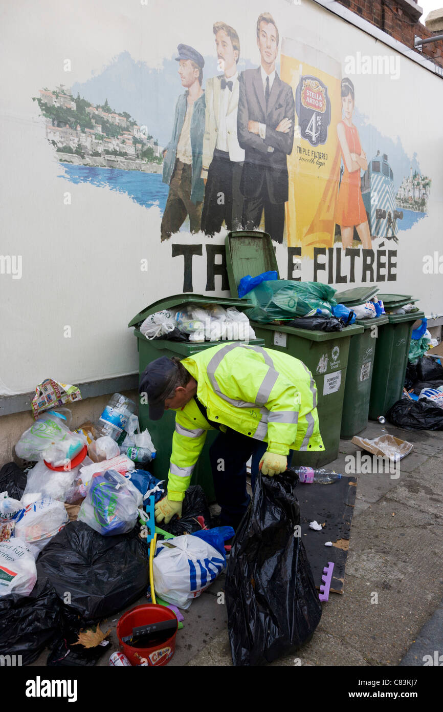 Workmen from Southwark Council clear away piles of street rubbish