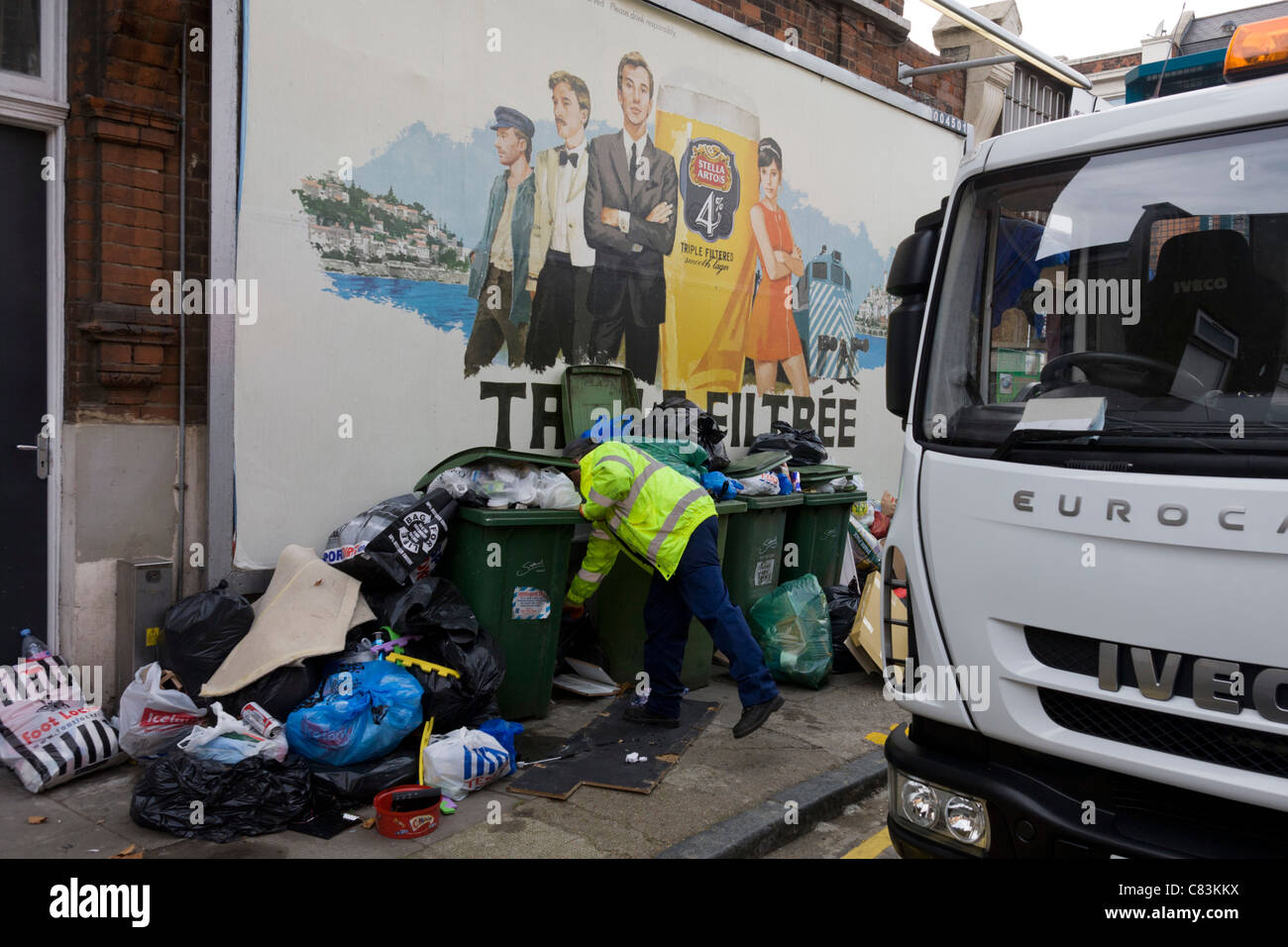 Workmen from Southwark Council clear away piles of street rubbish