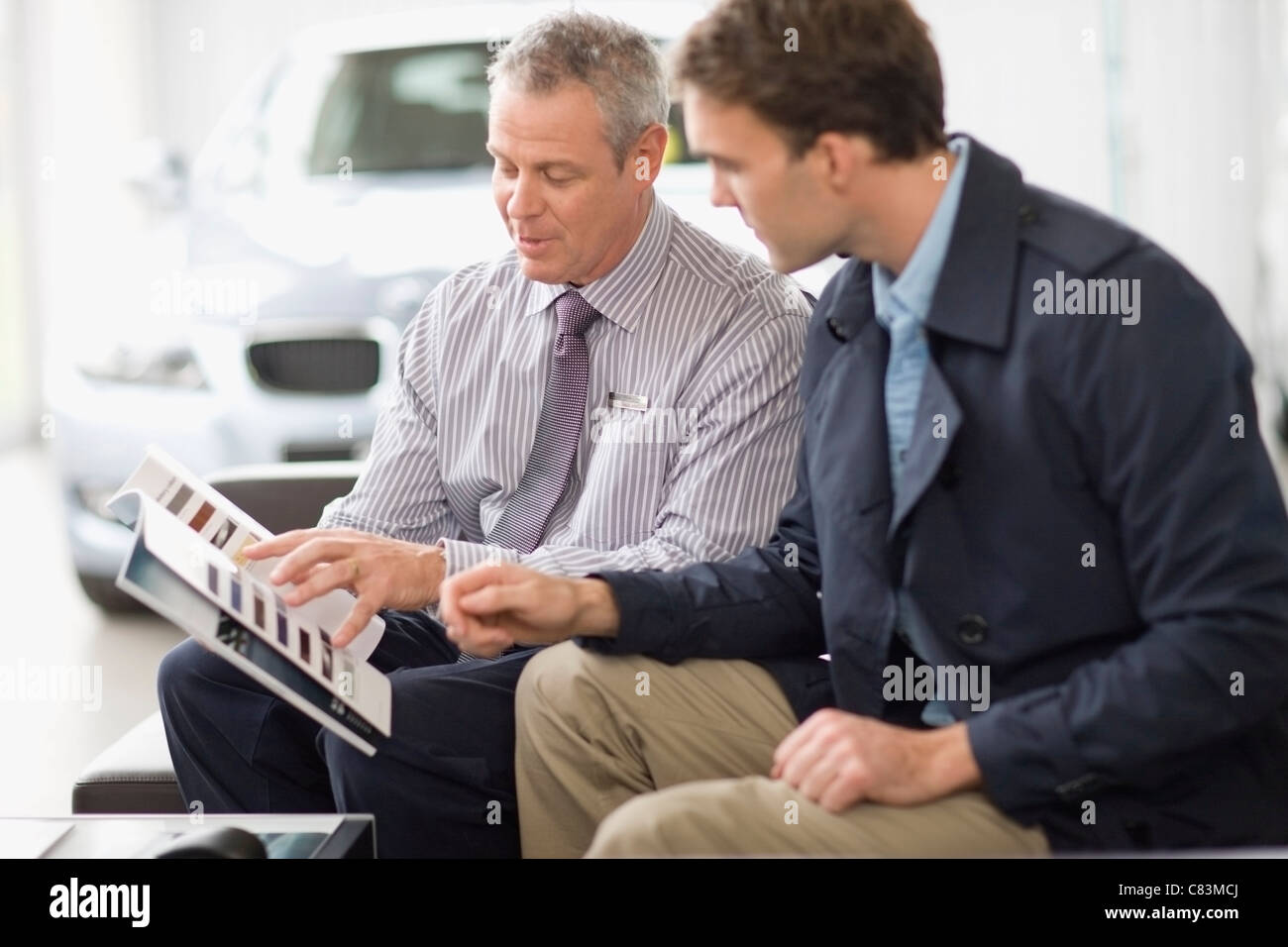 Car salesman talking with customer Stock Photo Alamy