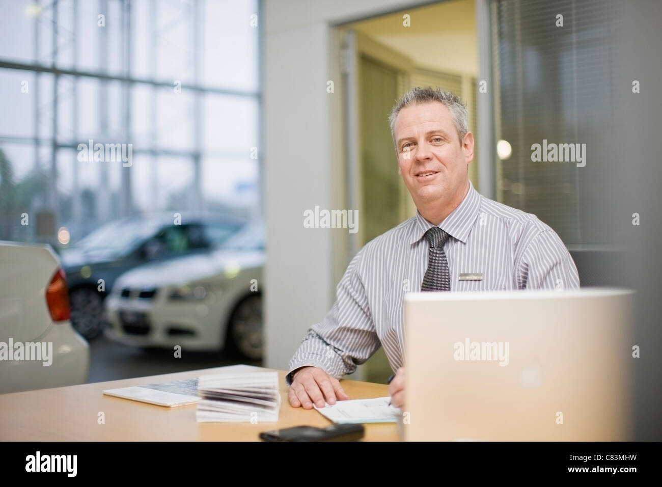 Car salesman sitting desk in hires stock photography and images Alamy