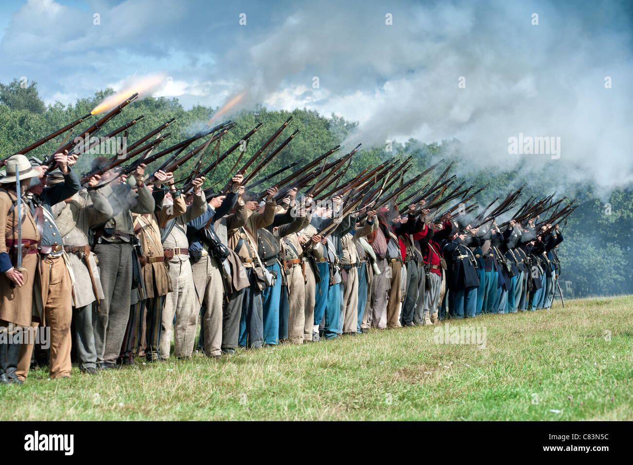 Mixed line of soldiers demonstrate the noise of a rifle company opening ...