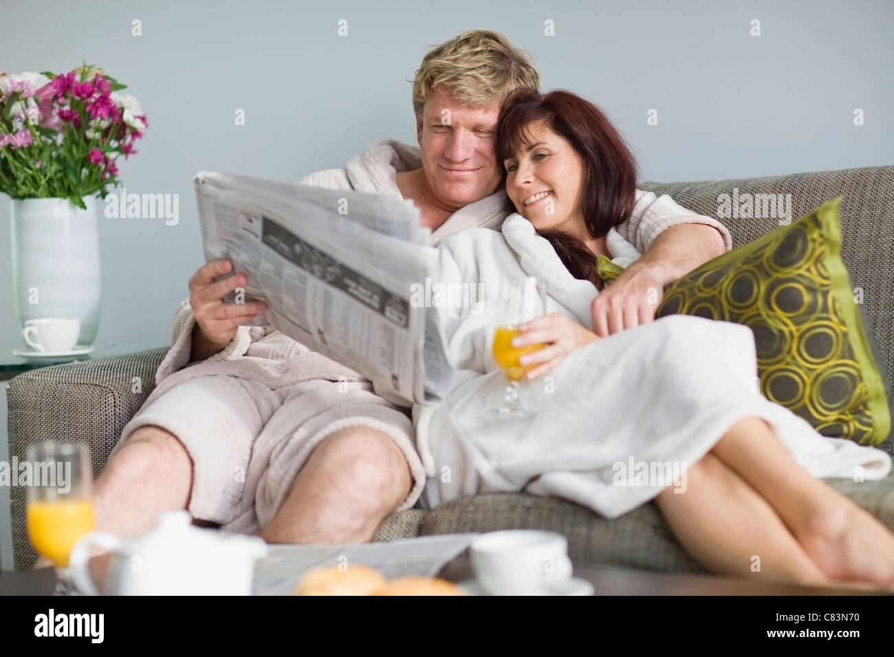 Couple in bathrobes having breakfast Stock Photo