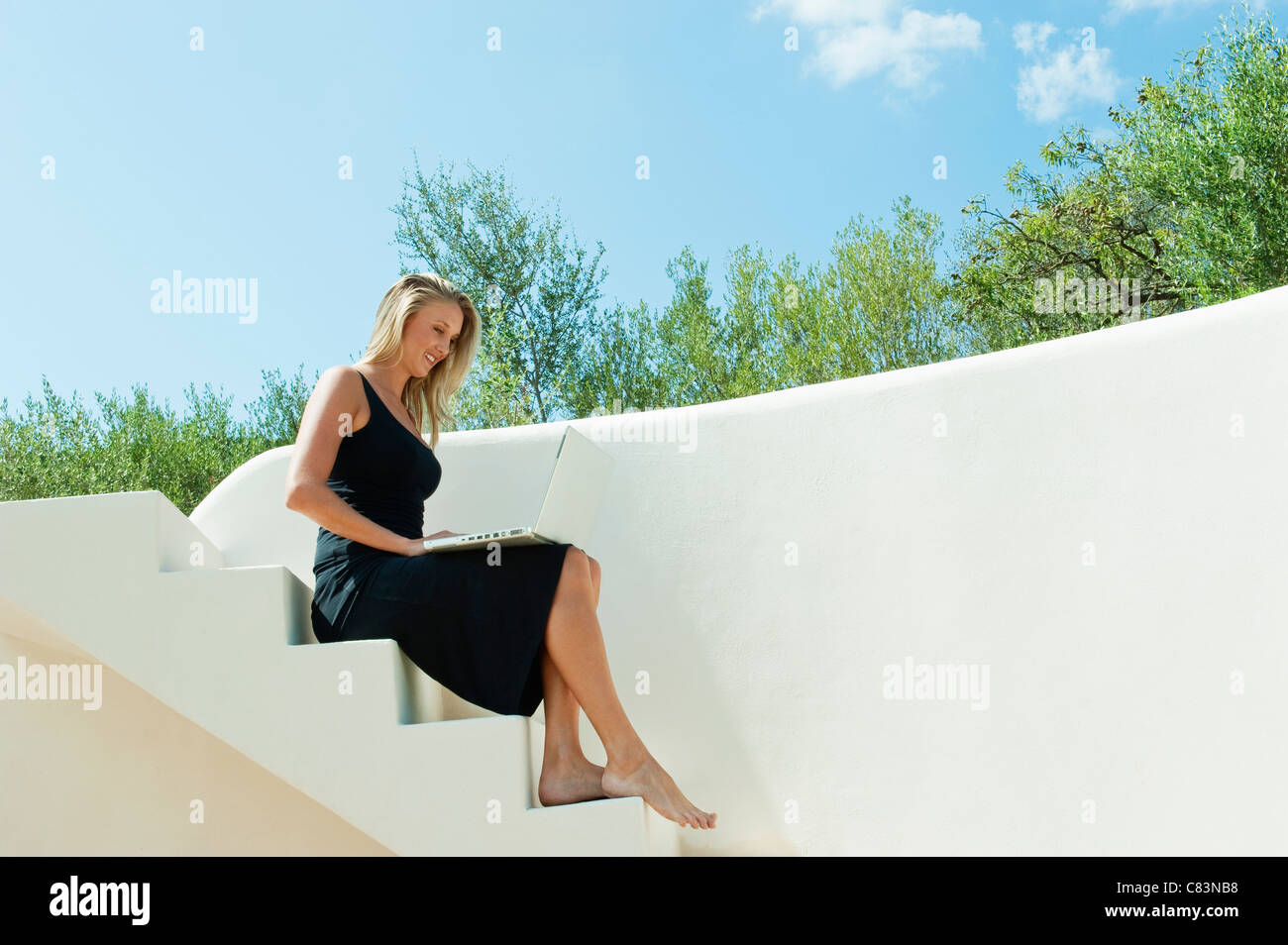 Woman sitting barefoot on steps hi-res stock photography and images - Alamy