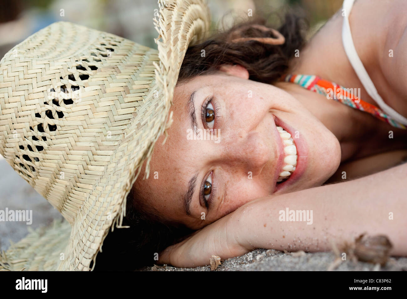 Close up of smiling woman wearing sunhat Stock Photo