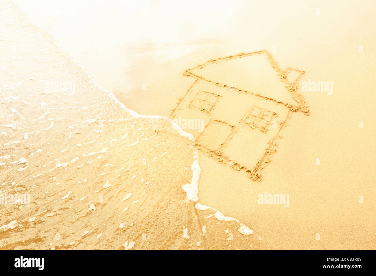 House in sand washed away by waves Stock Photo Alamy