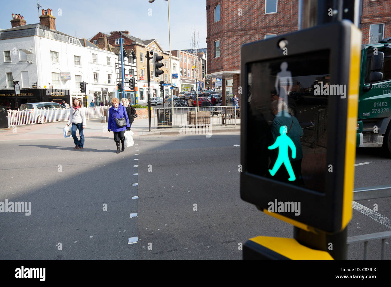 Closeup of pedestrian crossing button and display illuminated green