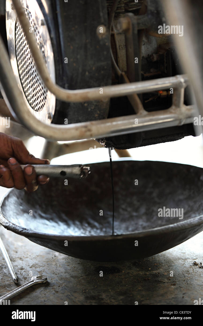 oil change on a Bullet Enfiled diesel Andhra Pradesh South India Stock
