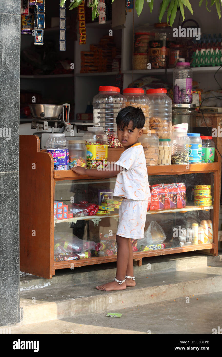 Little girl buying sweets at a shop Andhra Pradesh South India Stock Photo