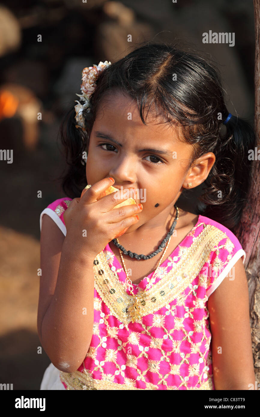 Young girl eating an apple Andhra Pradesh South India Stock Photo - Alamy