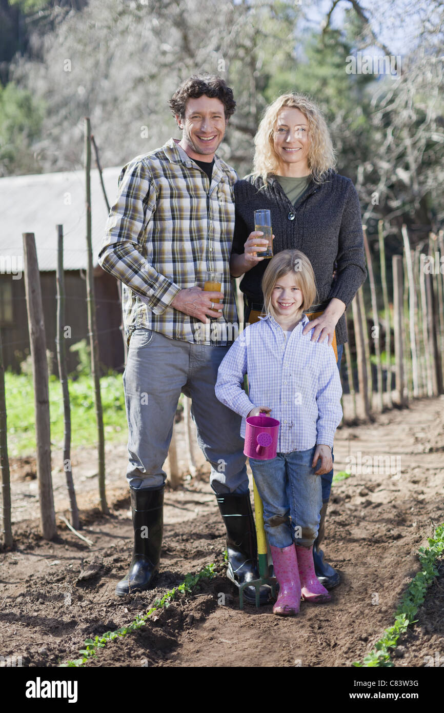 Family drinking juice and gardening Stock Photo