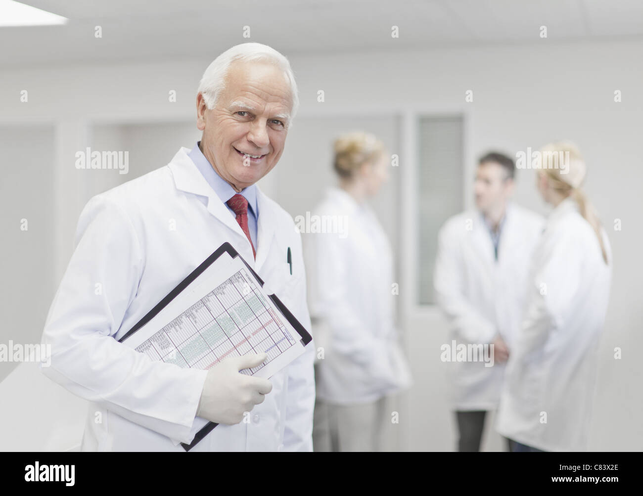 Scientist with notes in pathology lab Stock Photo