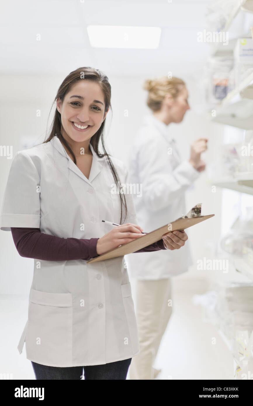 Smiling nurse holding clipboard Stock Photo - Alamy