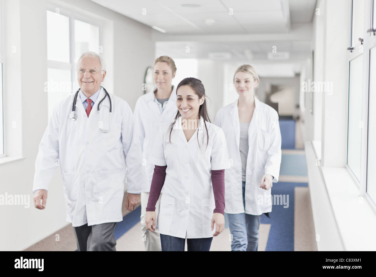 Doctors and nurses walking in hospital Stock Photo