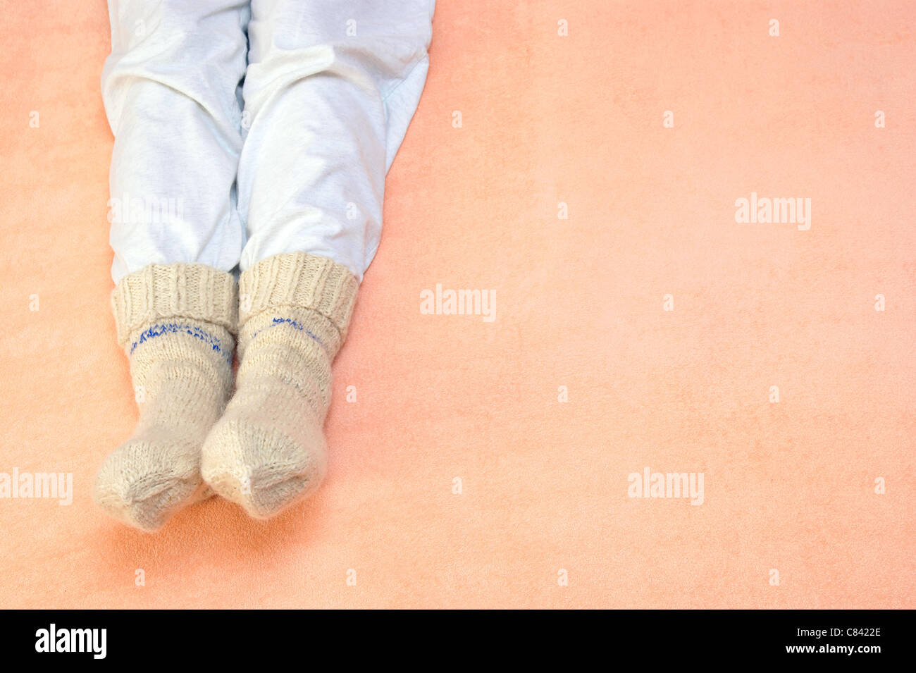 feet warming at a bed Stock Photo Alamy