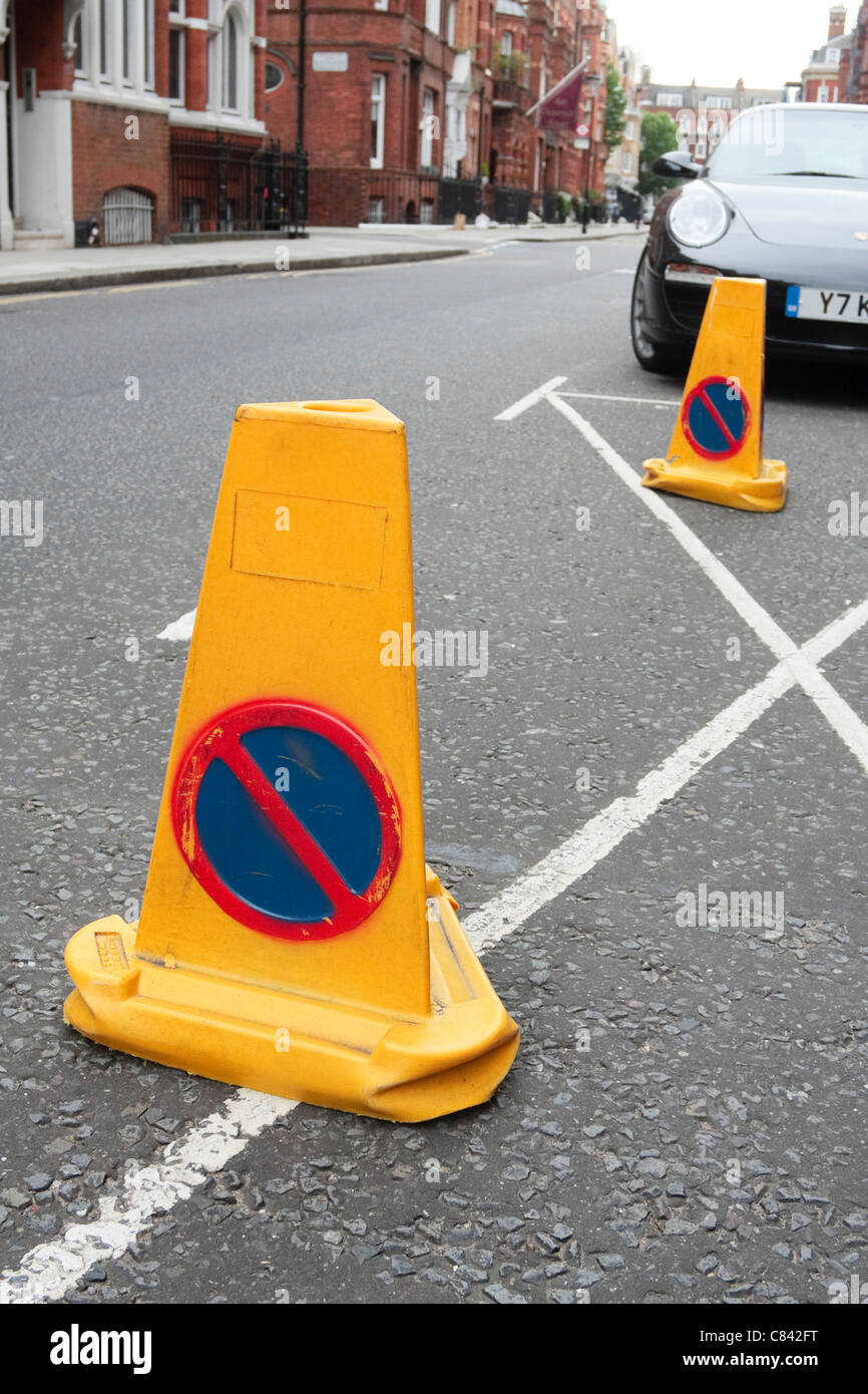 Police traffic cones mark out a no parking zone along a road in Chelsea, London, 2011 Stock Photo