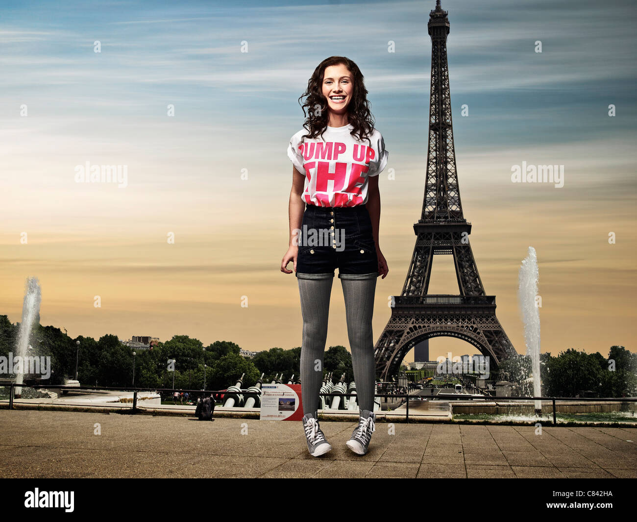 Girl standing in front of Eiffel Tower Stock Photo