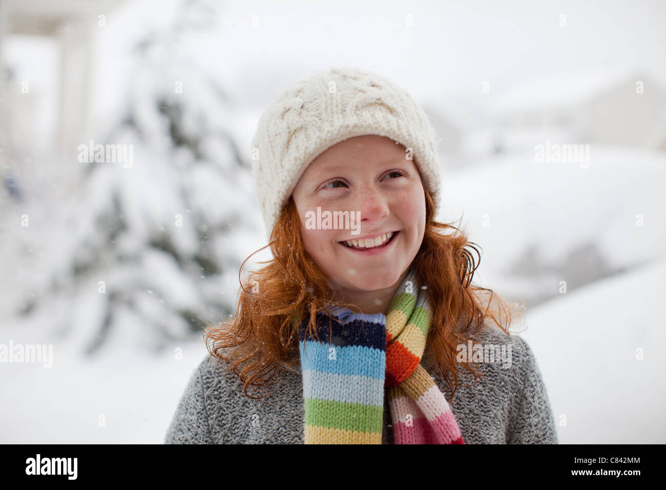 Smiling Caucasian girl standing in snow Stock Photo - Alamy