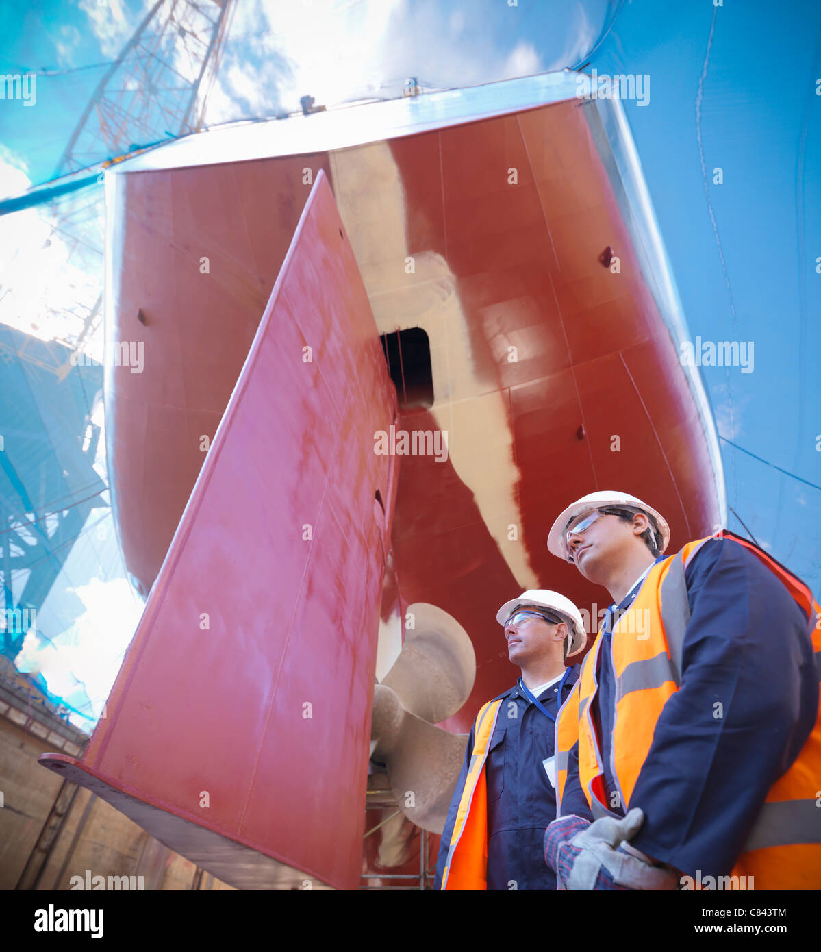 Workers standing on shipbuilding site Stock Photo Alamy