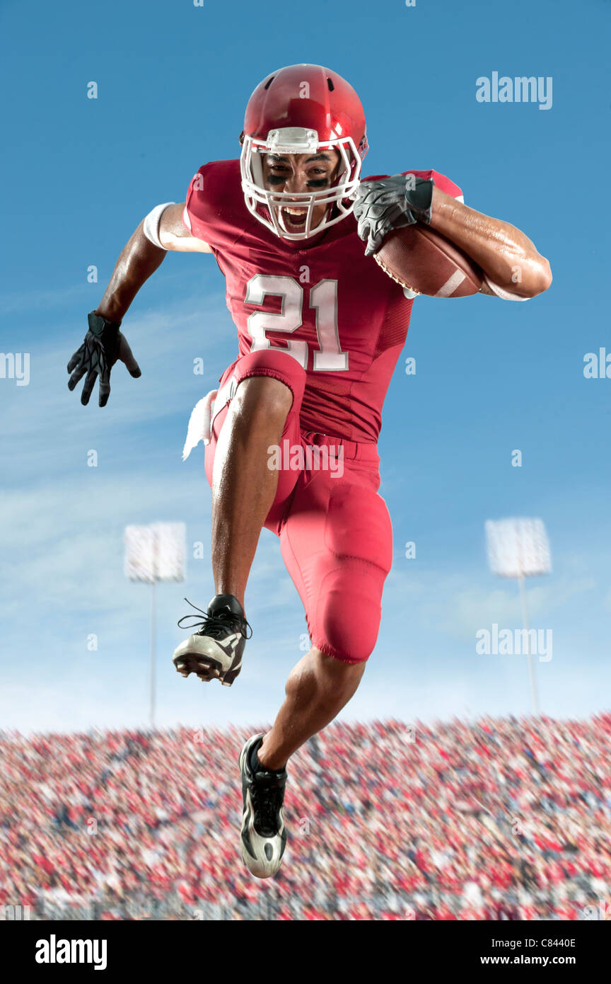 African American football player running with football Stock Photo