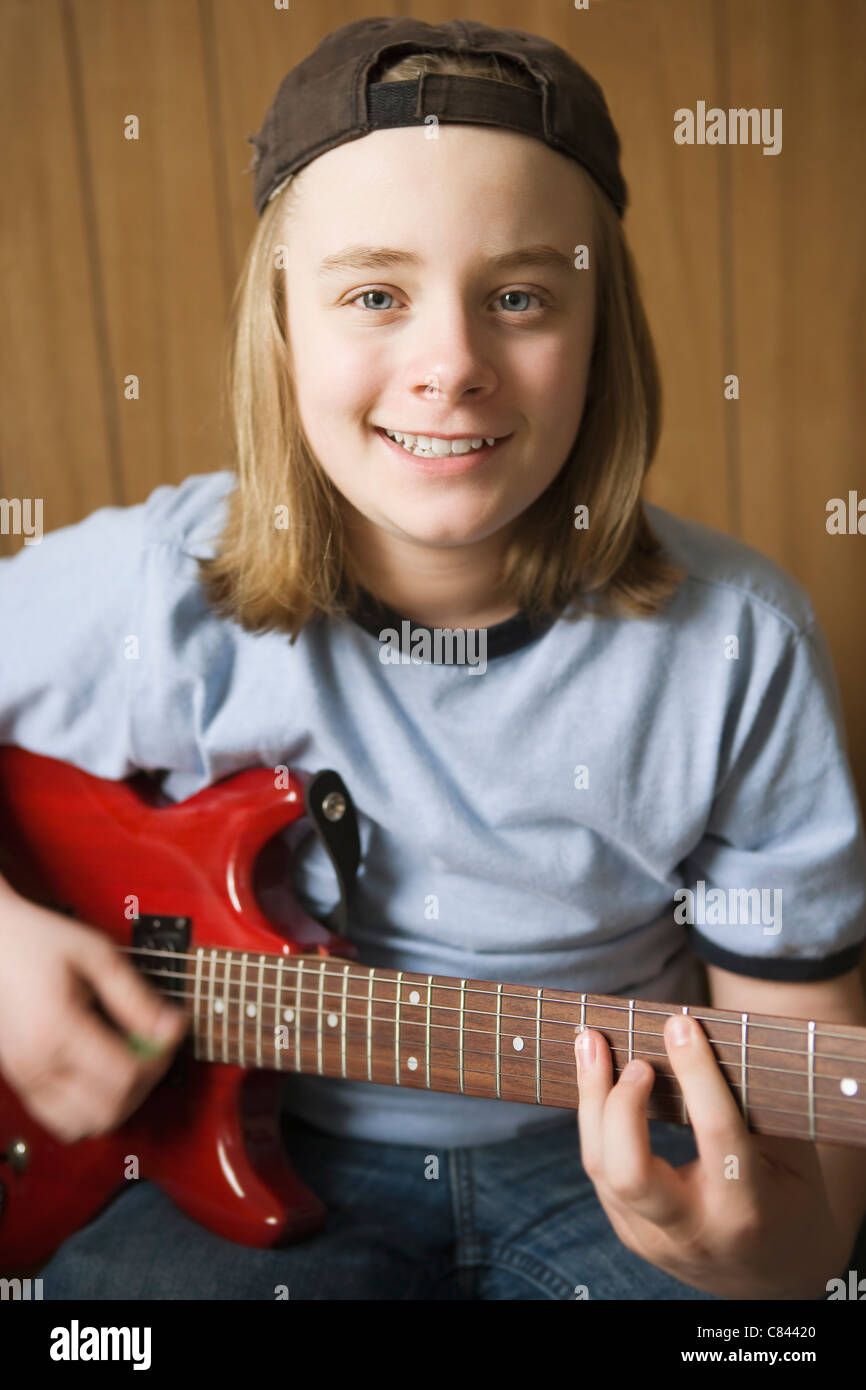Caucasian boy playing electric guitar Stock Photo Alamy