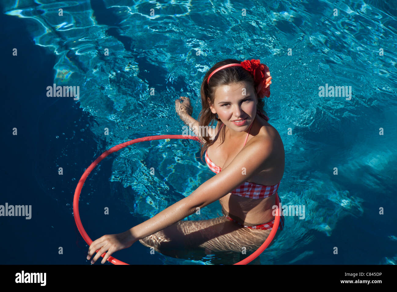 Woman playing with hula hoop in pool Stock Photo - Alamy