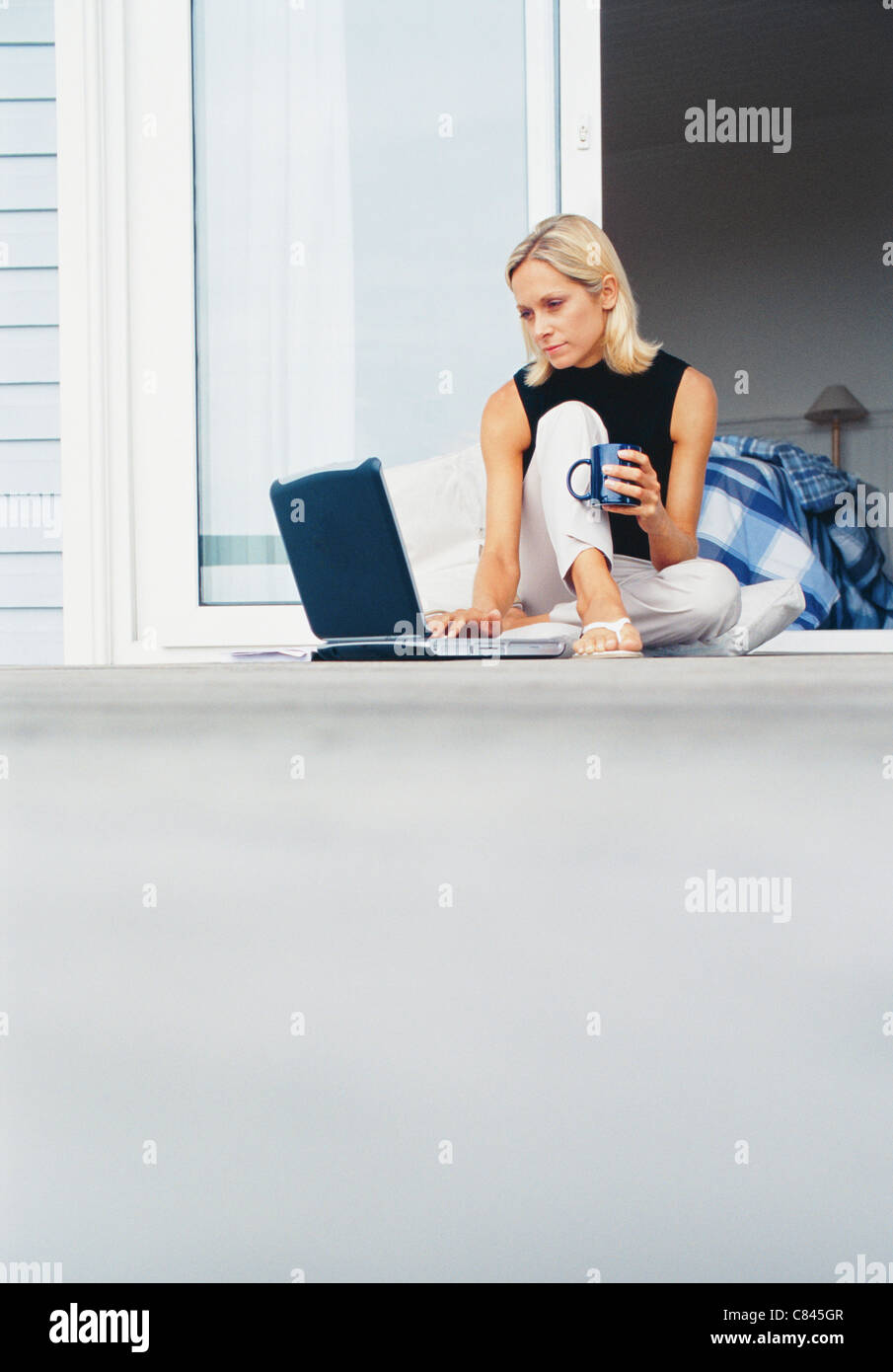 Woman sitting on porch holding hi-res stock photography and images - Alamy