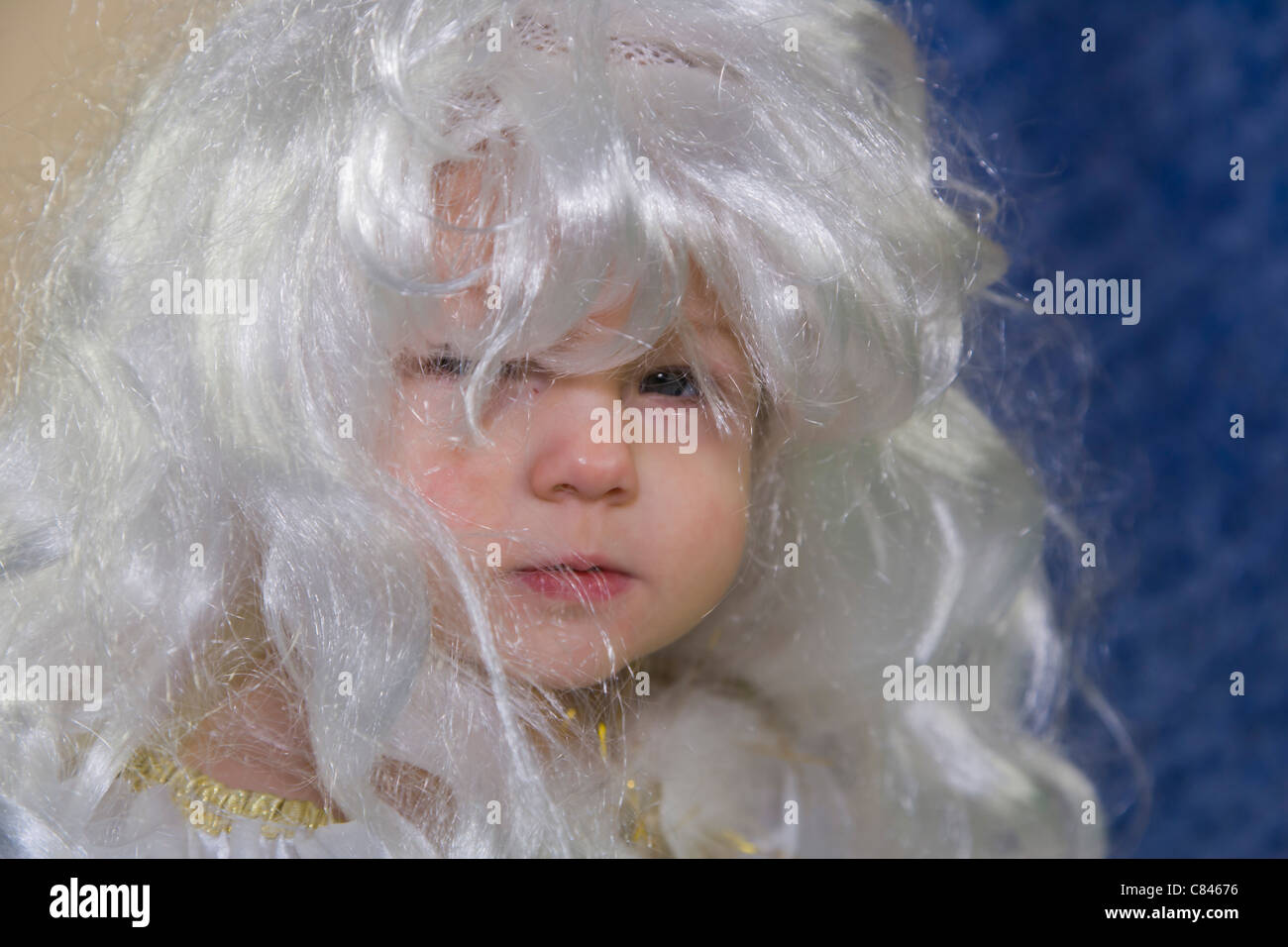 11 months old baby girl in angel dress and white wig Stock Photo