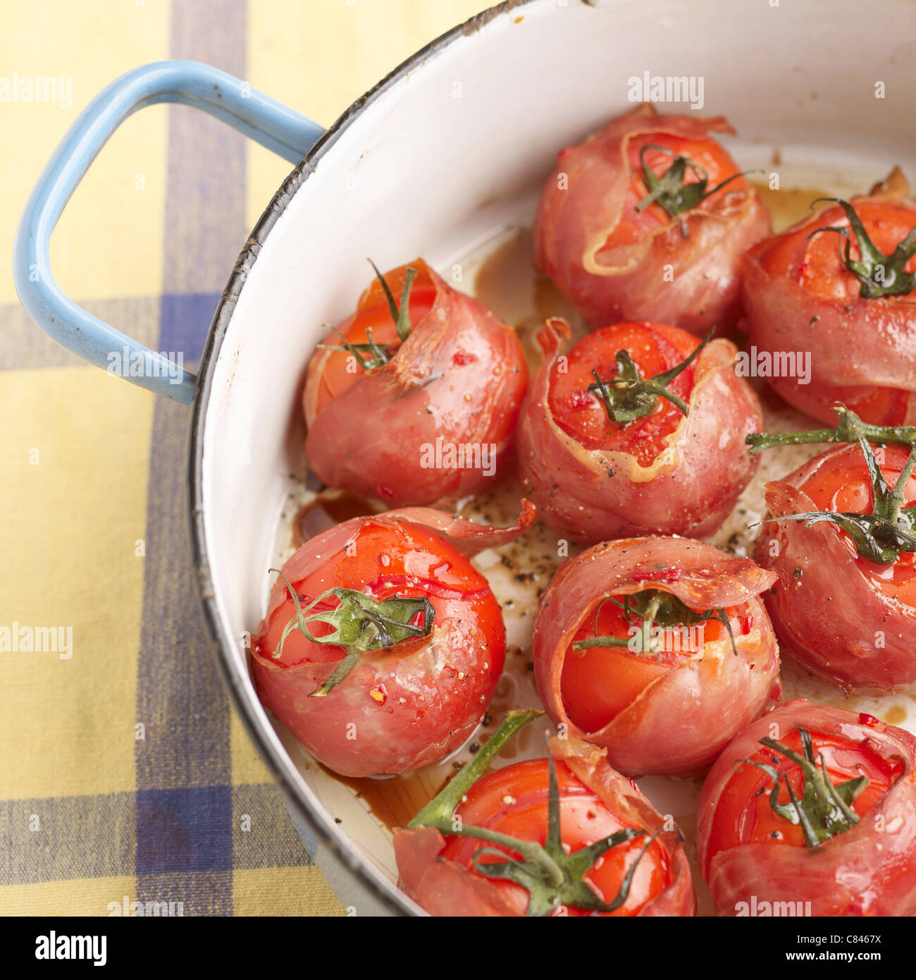 Pot of bacon wrapped tomatoes Stock Photo