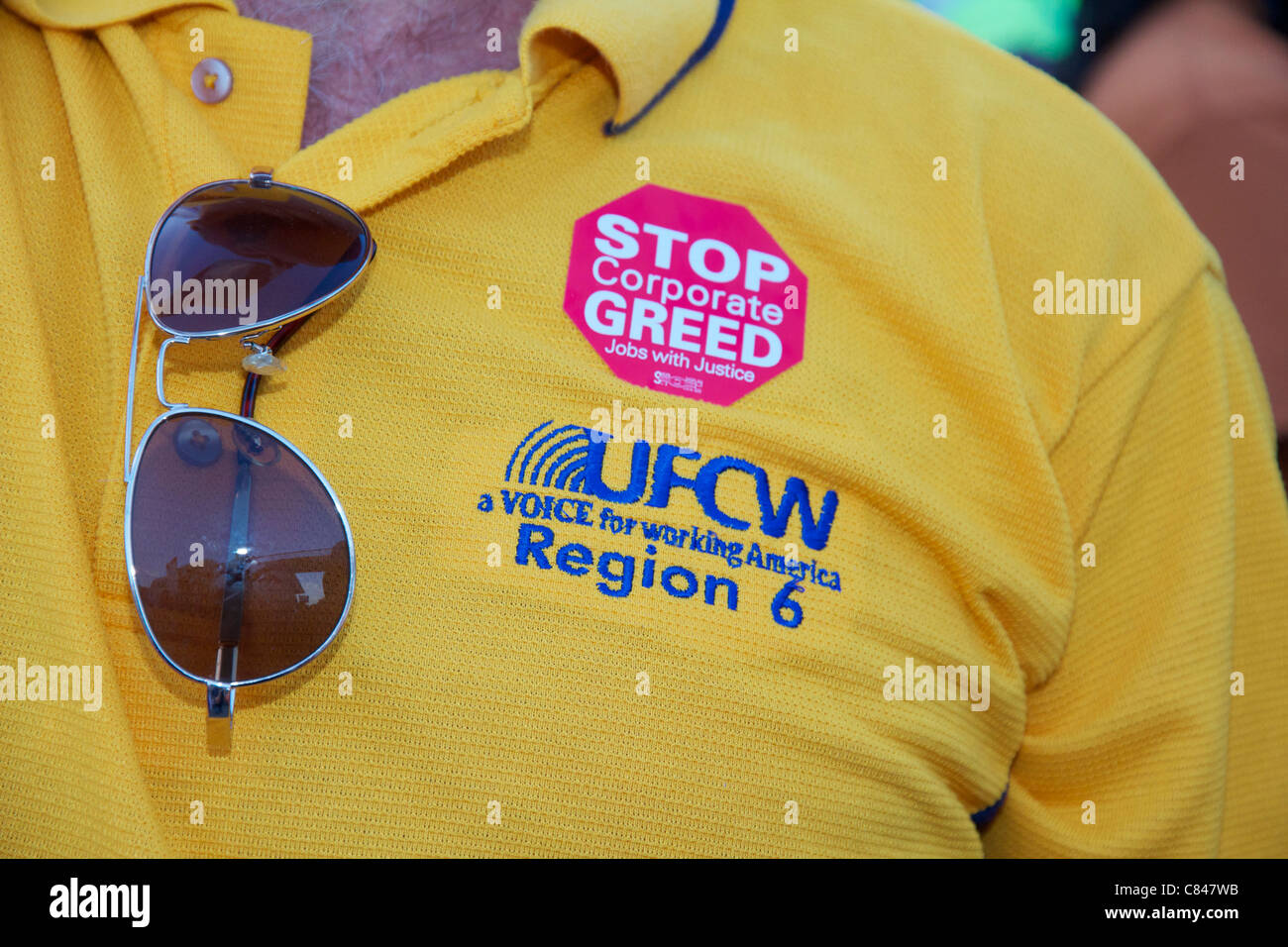 Union protesters shirt, Stop Corporate Greed sticker. Stock Photo