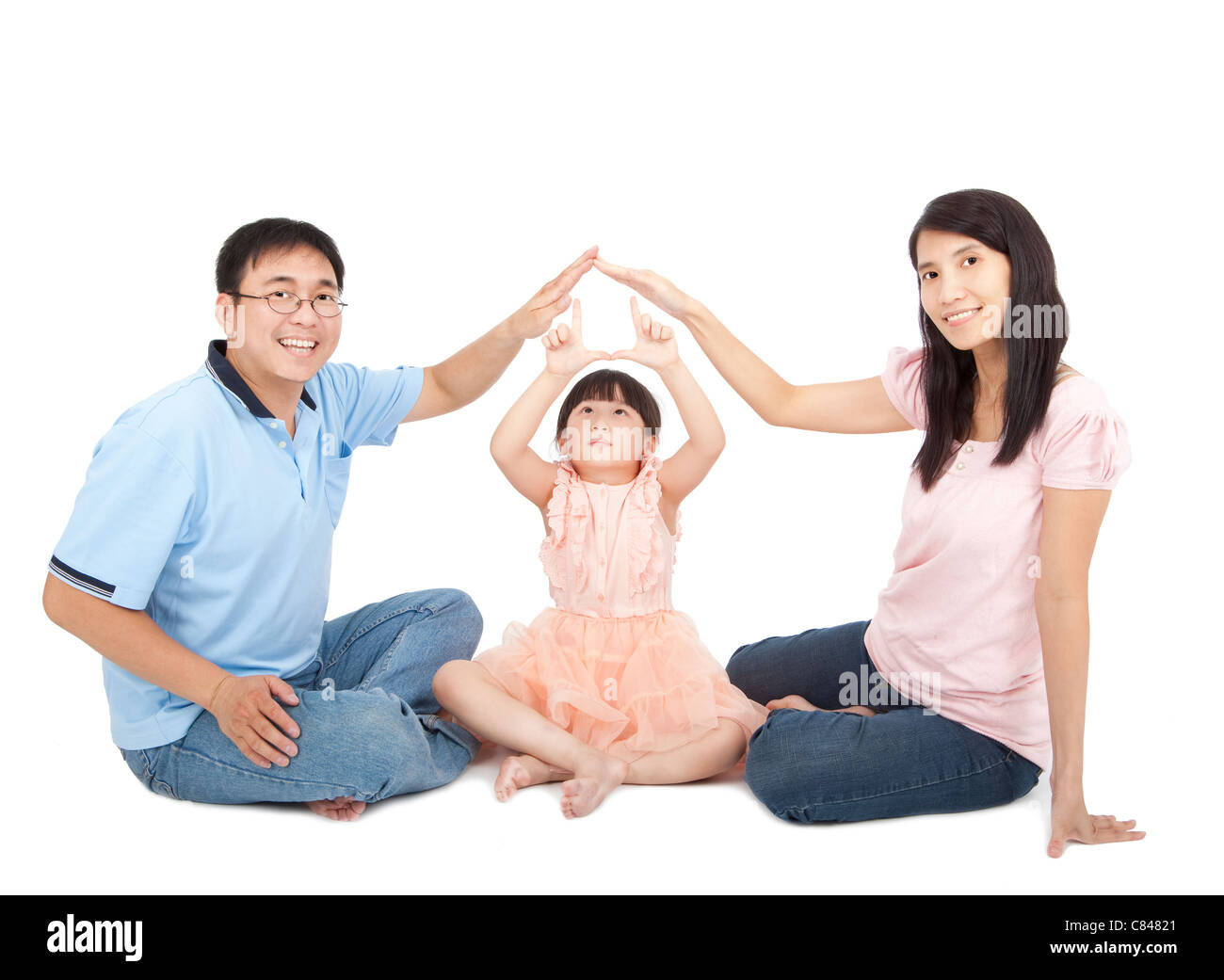happy young family showing home sign by hands Stock Photo