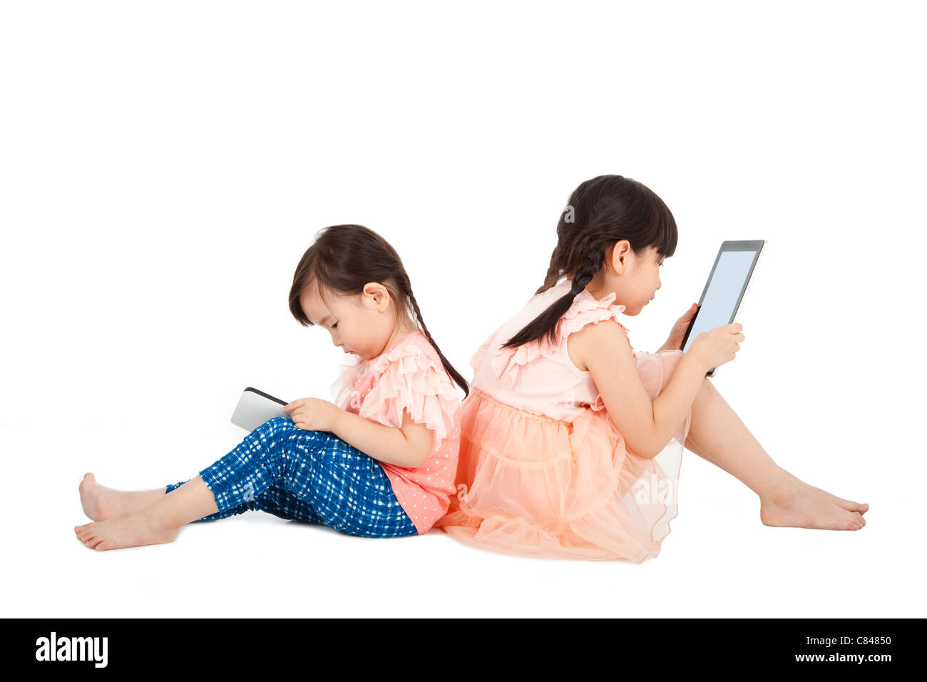 Two girls using touchscreen tablet PC Stock Photo