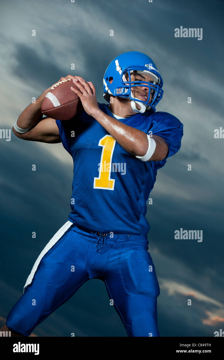 Black football player about to throw football Stock Photo Alamy