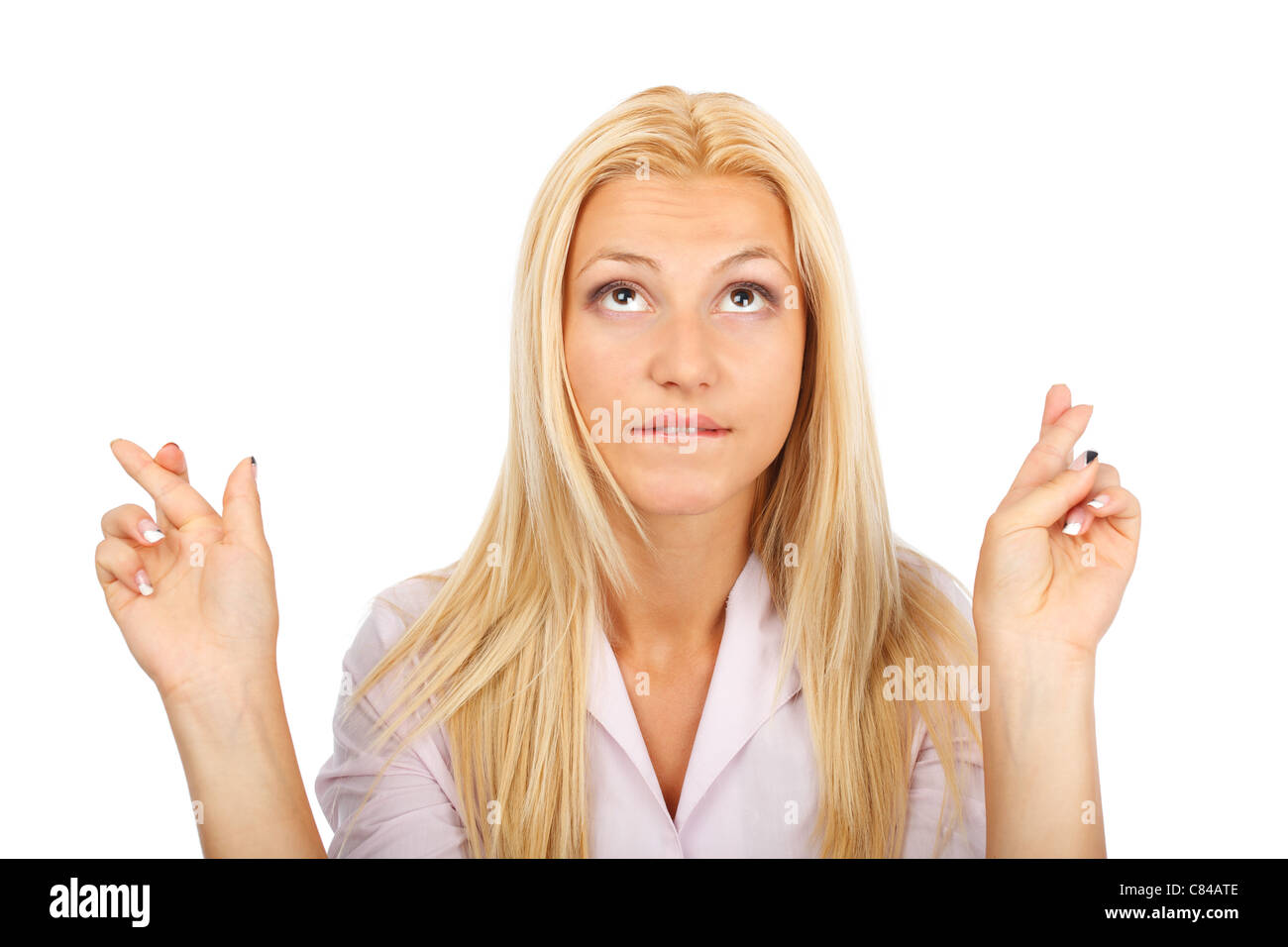 Closeup portrait of a woman keeping fingers crossed, isolated on white
