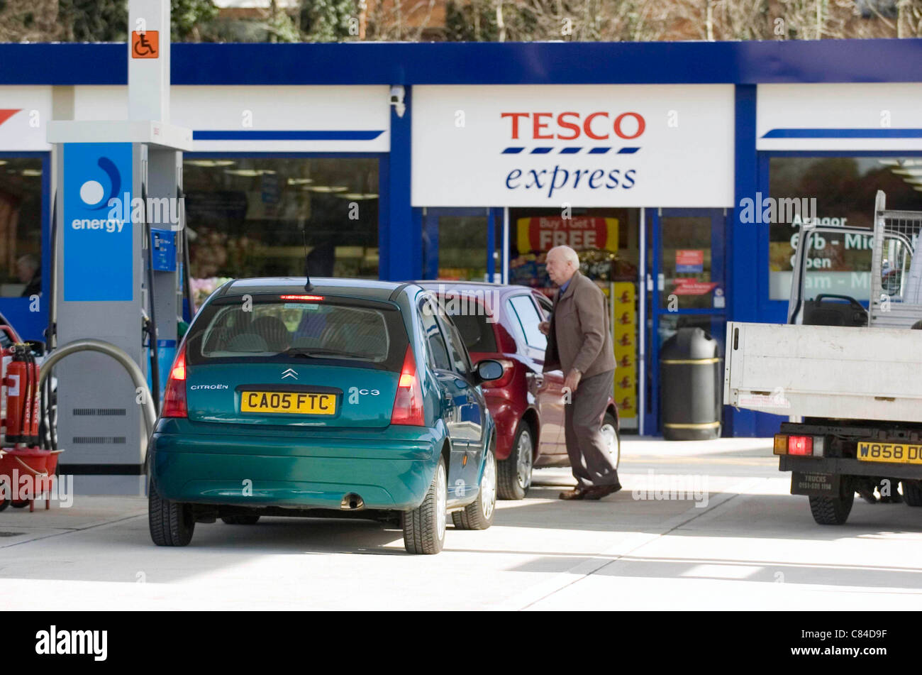 Drivers filling up with fuel at a Tesco Express petrol station Stock