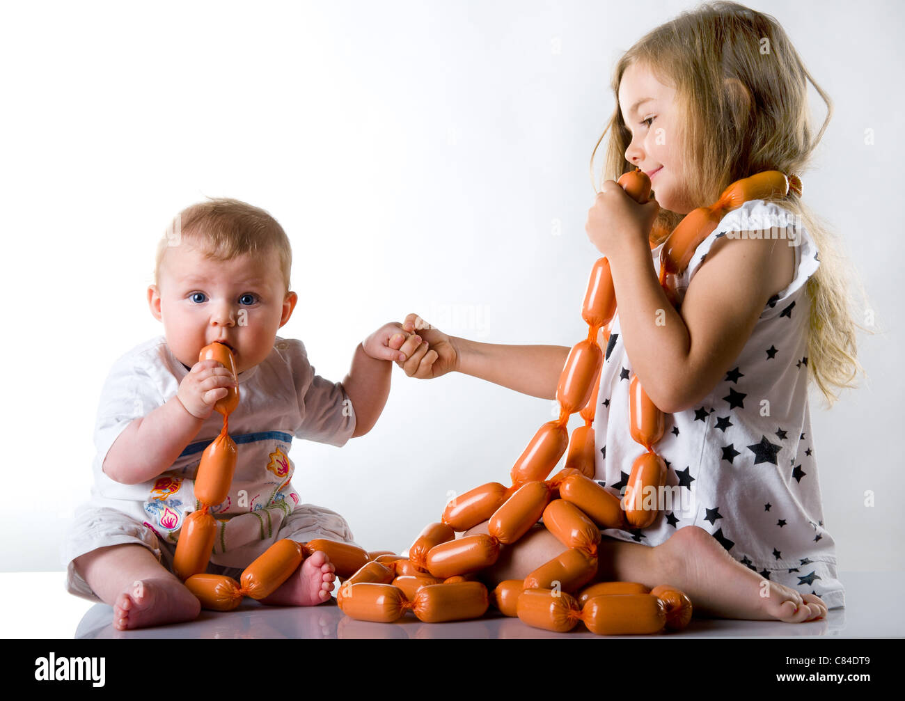 children playing with sausage Stock Photo Alamy