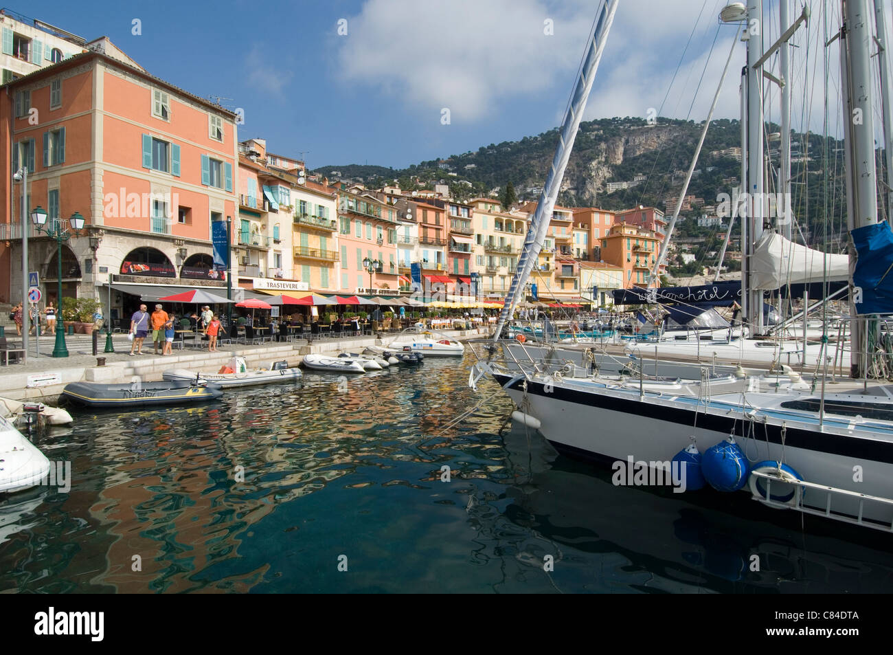 Villefranche sur Mer, Harbour front and yacht, tourists Stock Photo