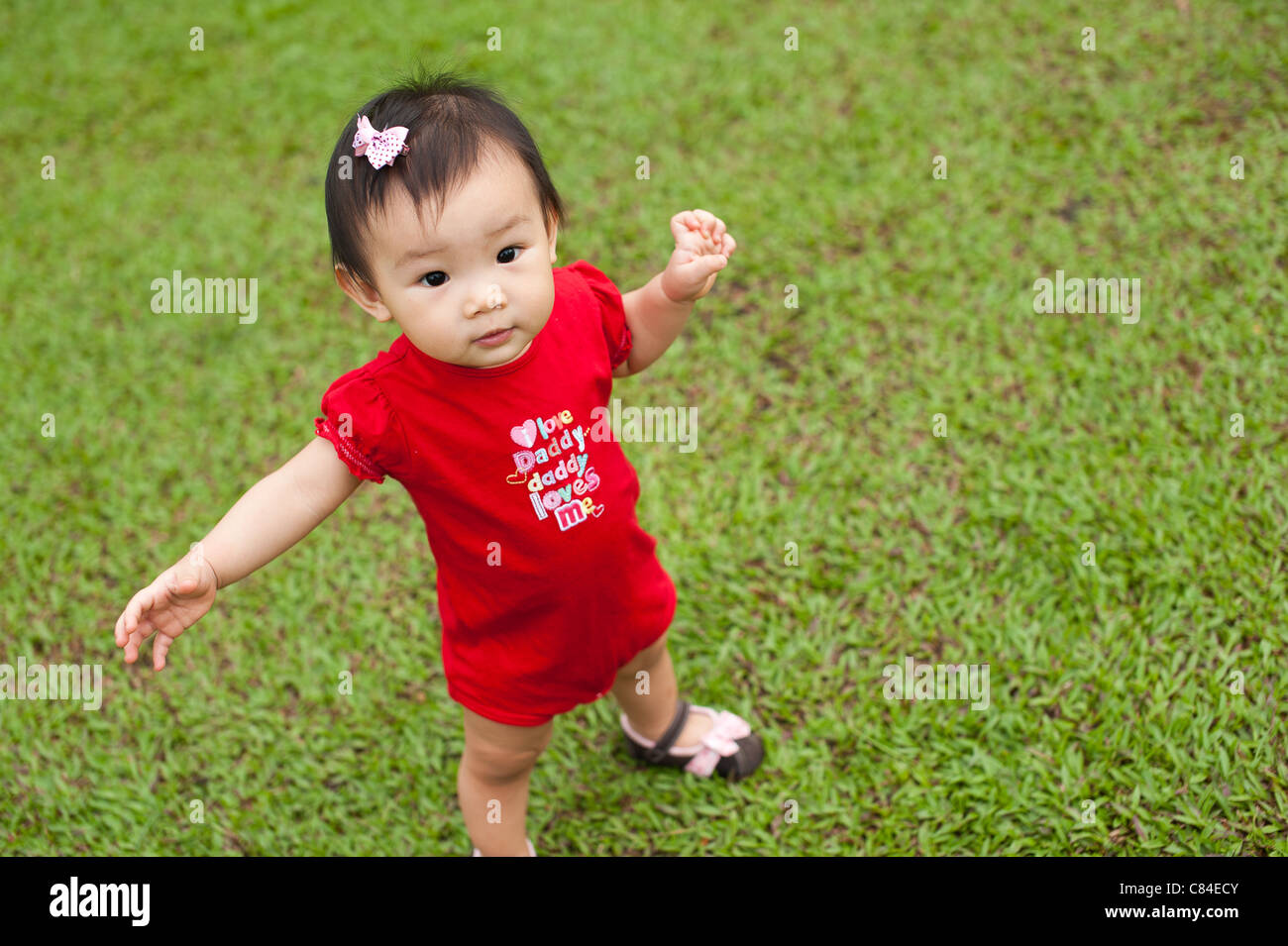 Eleven month old Asian baby girl in a playground Stock Photo