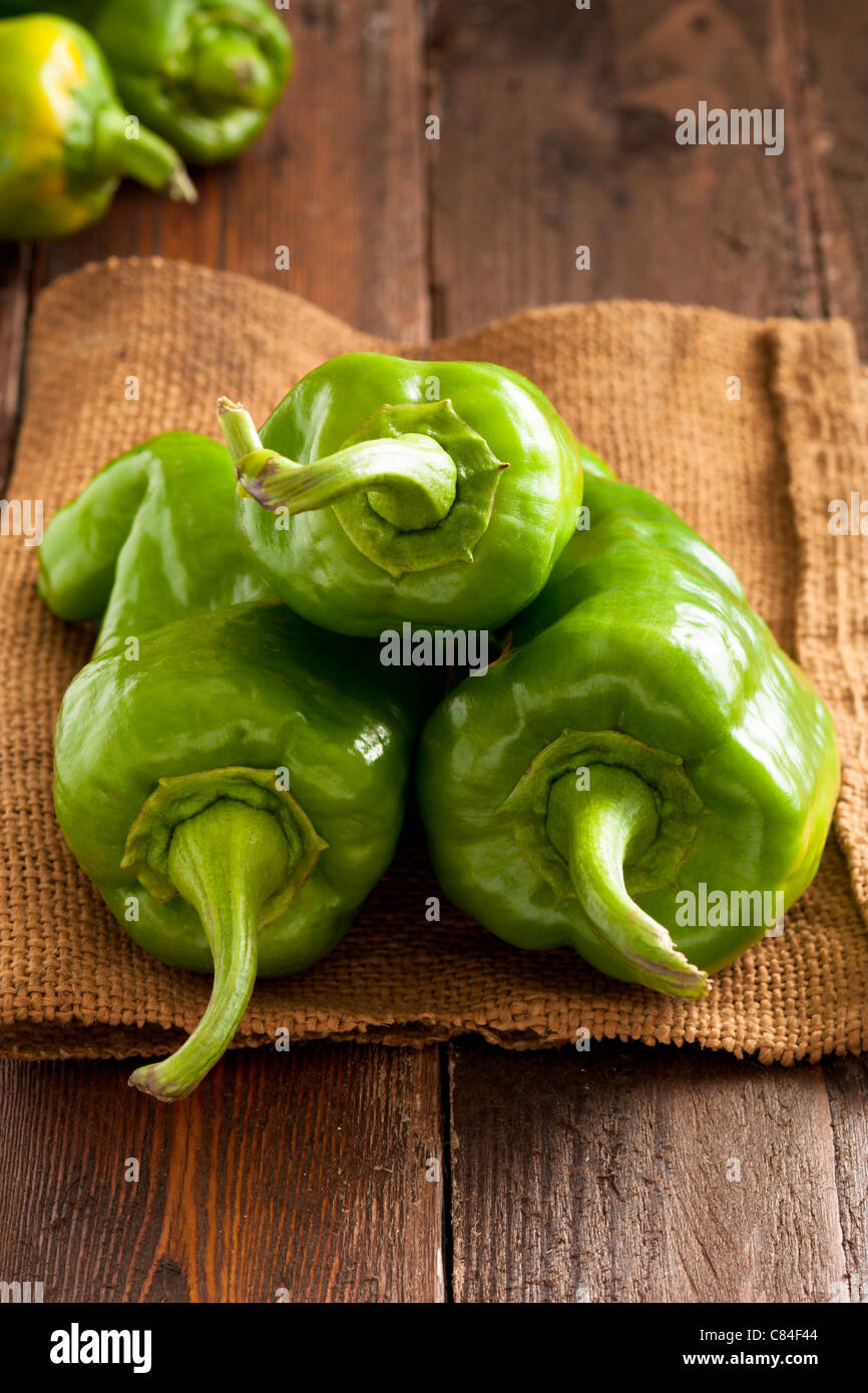 Green Bell Peppers on Jute and Wood Stock Photo