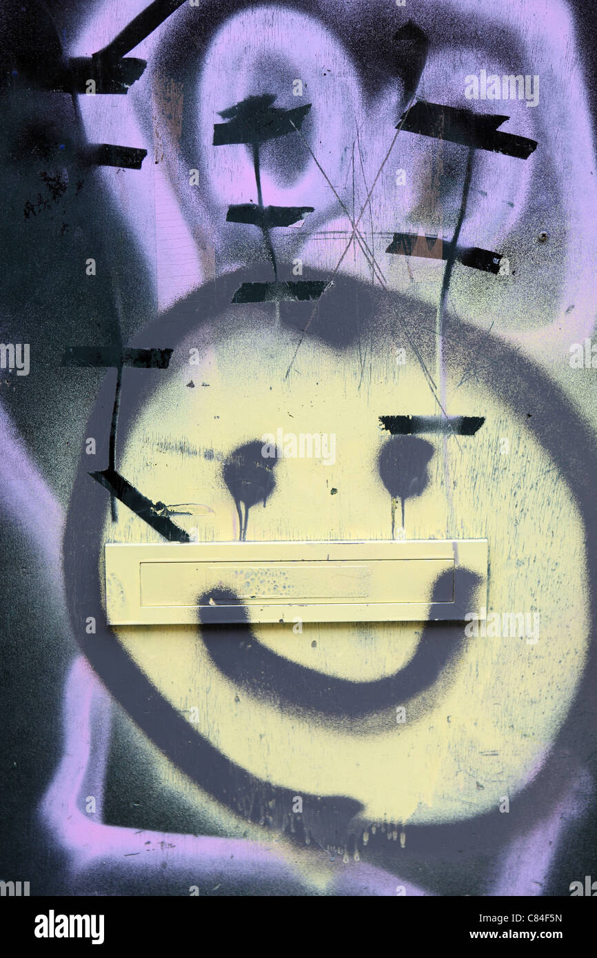 Smiley face, graffiti,  on one of few remaining squatter houses in central Amsterdam, icon, smile, yellow, creative, vandalism Stock Photo