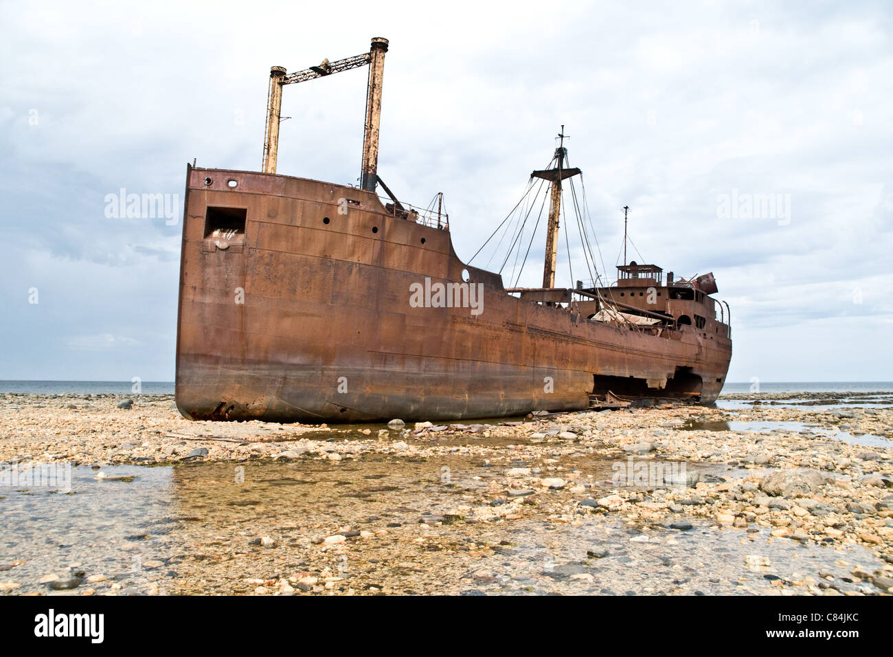 The 1960's era shipwreck the 'SS Ithaca' at low-tide grounded on the Arctic Ocean coast at Hudson Bay, near Churchill, Manitoba, Canada. Stock Photo
