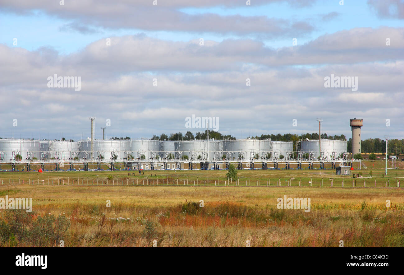 white tanks in tank farm with clouds in sky Stock Photo