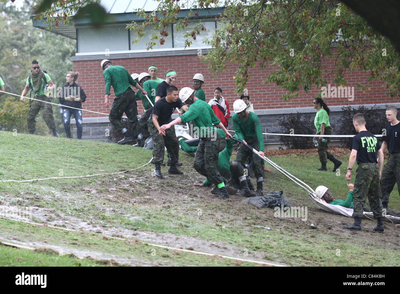 First year university students at military college doing an obstacle course Stock Photo