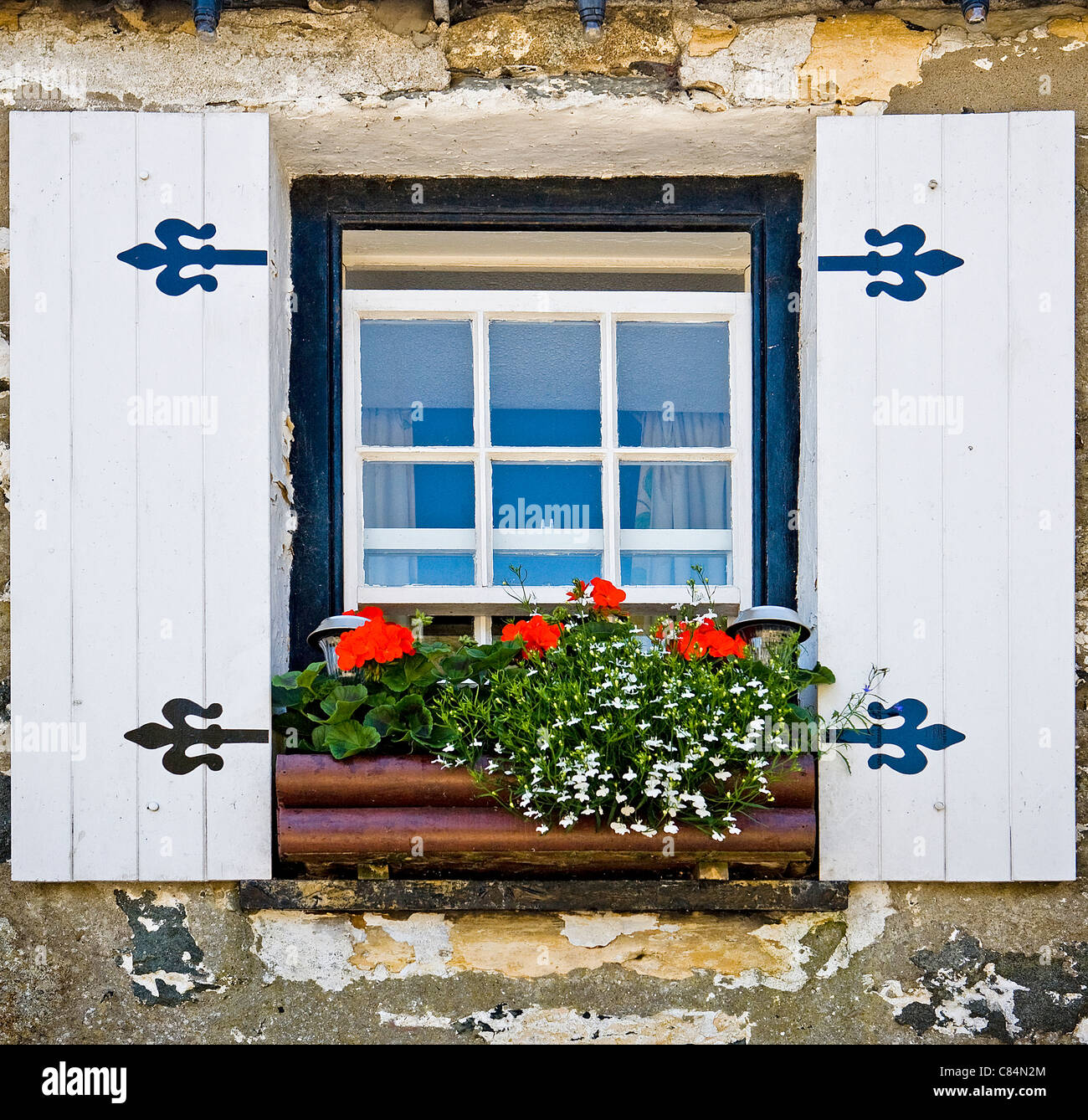 Sash Window In A Cornish Cottage With Artificial Wooden Shutters And Window Box Full Of Colourful Flowers Stock Photo Alamy