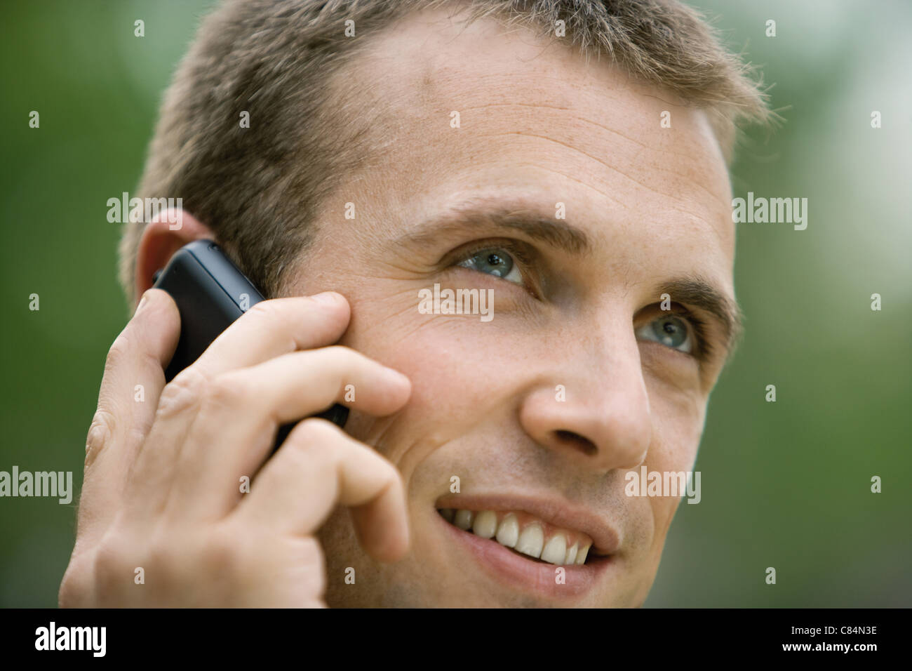 Man using cell phone outdoors Stock Photo